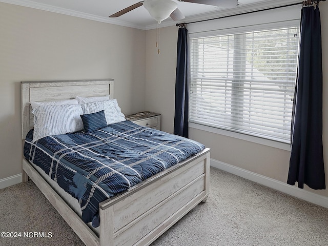 carpeted bedroom featuring ornamental molding and ceiling fan