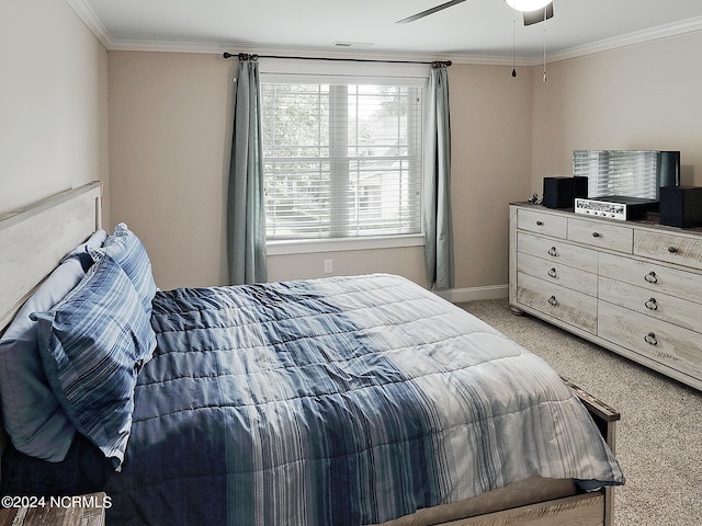 bedroom featuring carpet flooring, ornamental molding, and ceiling fan