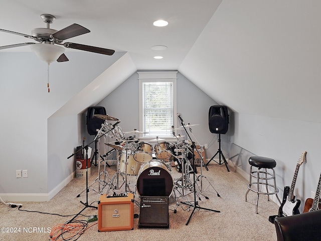 exercise room featuring lofted ceiling, ceiling fan, and carpet floors