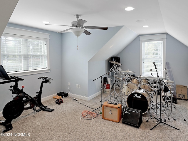 exercise area with ceiling fan, carpet floors, and lofted ceiling