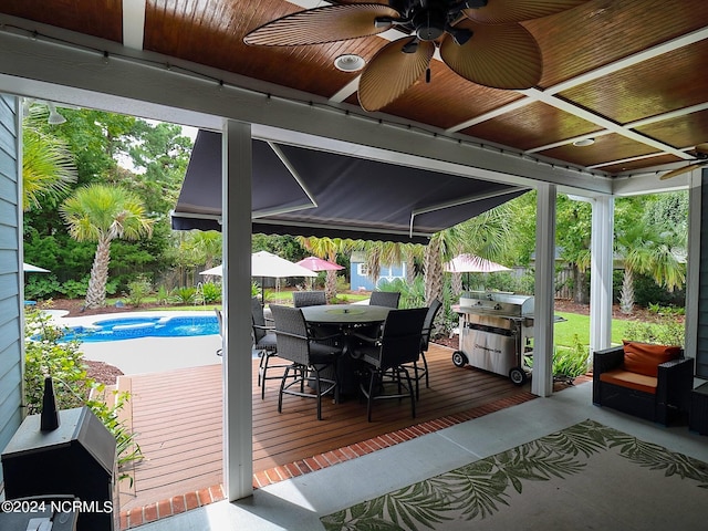 view of patio / terrace featuring ceiling fan, a pool side deck, and a grill