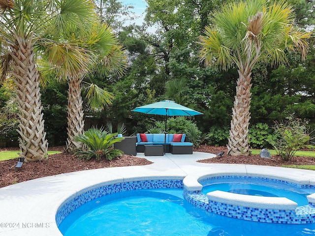 view of swimming pool with a patio, an outdoor living space, and an in ground hot tub