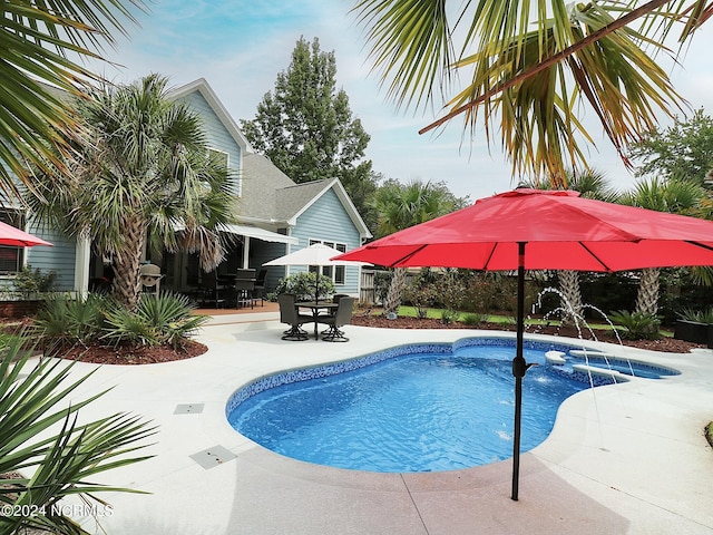 view of swimming pool featuring a patio and pool water feature