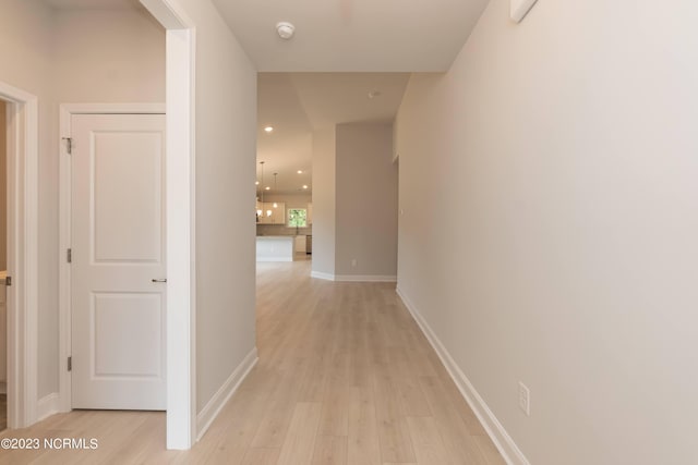 corridor with light hardwood / wood-style flooring