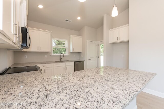 kitchen featuring sink, stainless steel appliances, white cabinetry, and light wood-type flooring