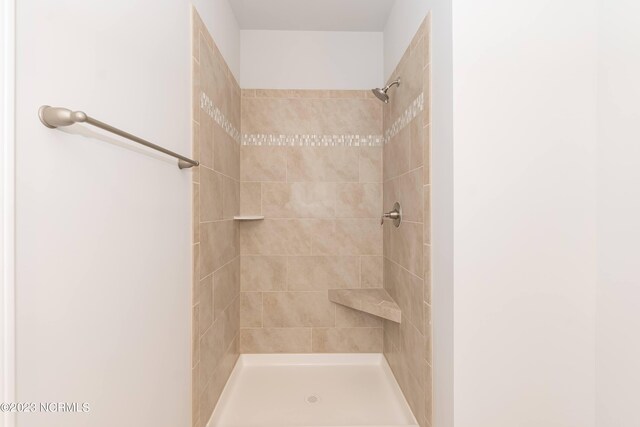 bathroom with tiled shower