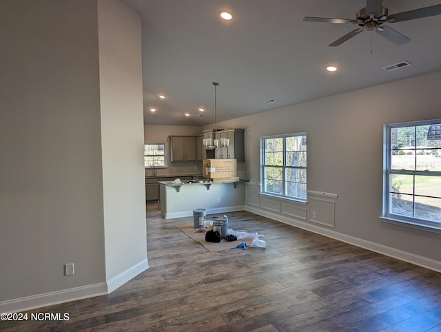 interior space featuring hardwood / wood-style floors, gray cabinets, plenty of natural light, and decorative light fixtures