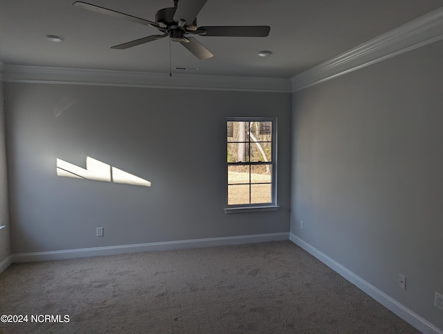 carpeted empty room with ceiling fan and crown molding