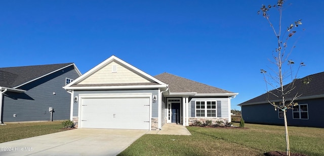 craftsman-style home with a front yard and a garage