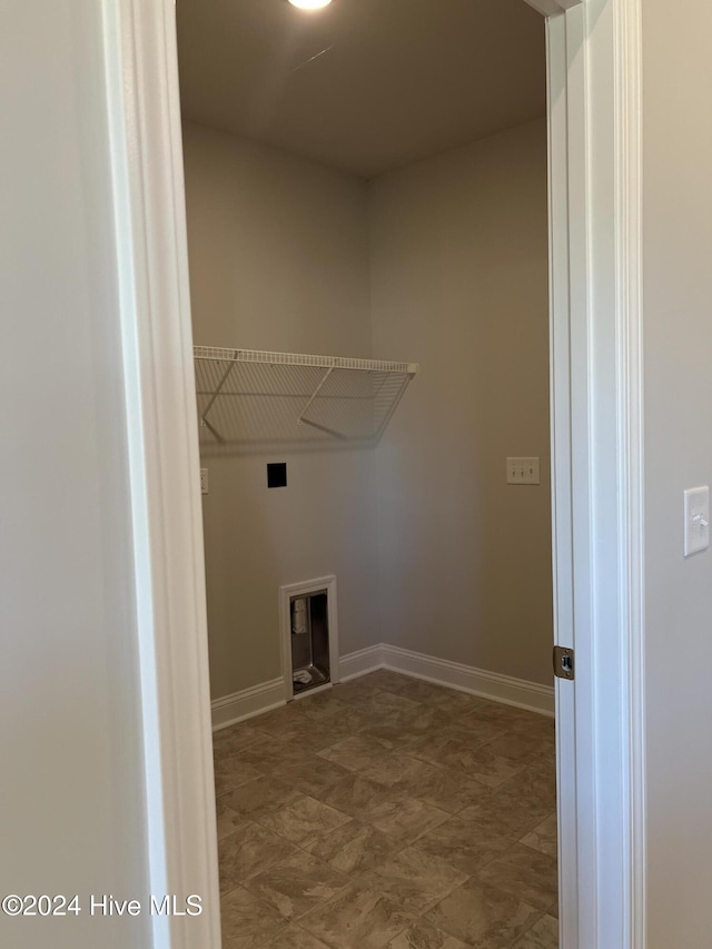 washroom with hookup for an electric dryer