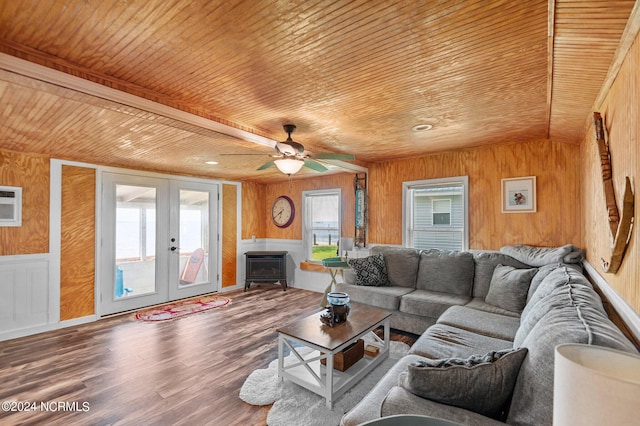 living room featuring wooden walls, wood ceiling, ceiling fan, wood finished floors, and french doors