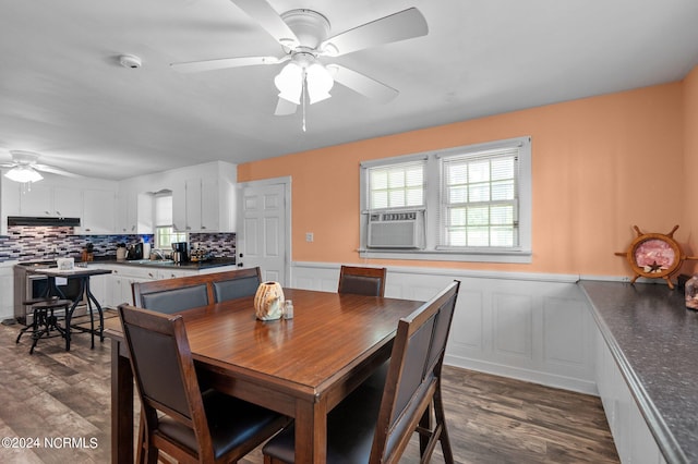 dining area with a wainscoted wall, cooling unit, dark wood finished floors, and a wealth of natural light