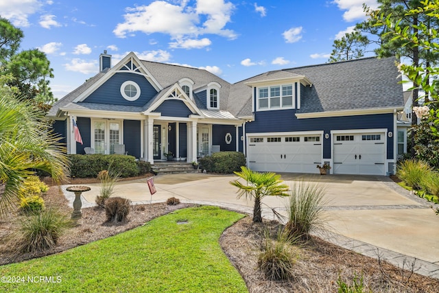 view of front of home with driveway, a chimney, and roof with shingles