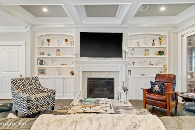 living room with built in features, a high end fireplace, coffered ceiling, and wood finished floors