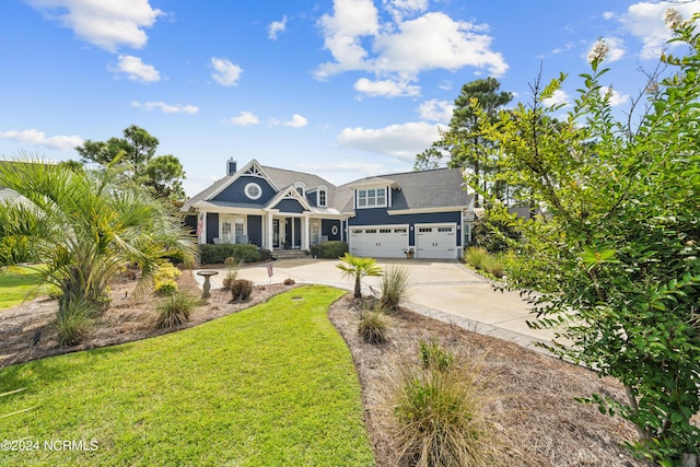 view of front of property featuring a garage, a front yard, and concrete driveway