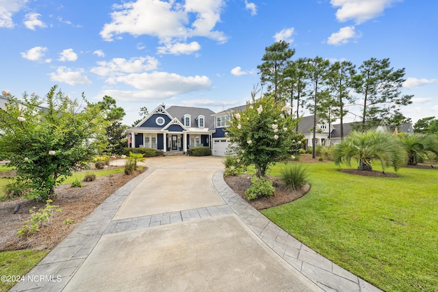 view of front of home featuring a garage, driveway, and a front lawn