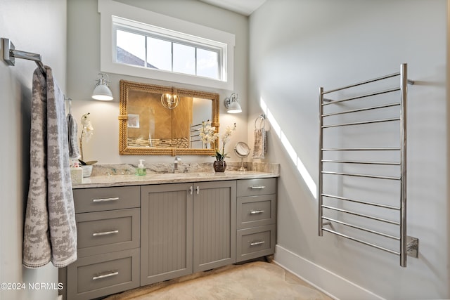 bathroom featuring radiator heating unit, baseboards, and vanity