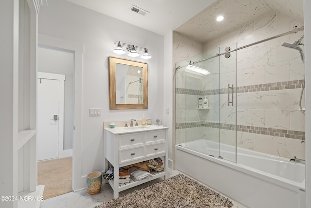 bathroom featuring marble finish floor, bath / shower combo with glass door, and vanity