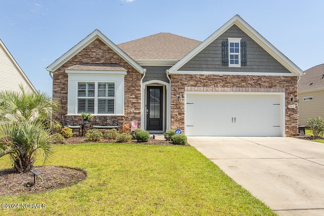 craftsman house with a garage, central air condition unit, and a front lawn