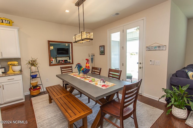 dining space with dark wood-type flooring