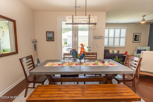 dining space with ceiling fan and wood-type flooring