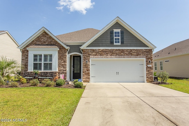 craftsman-style house with a garage and a front lawn