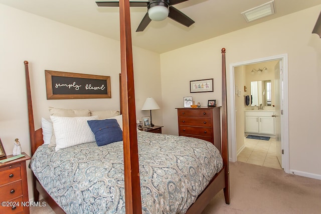 bedroom featuring light colored carpet, connected bathroom, and ceiling fan