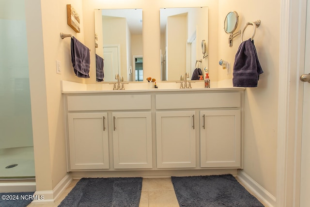 bathroom with tile patterned flooring, an enclosed shower, and vanity