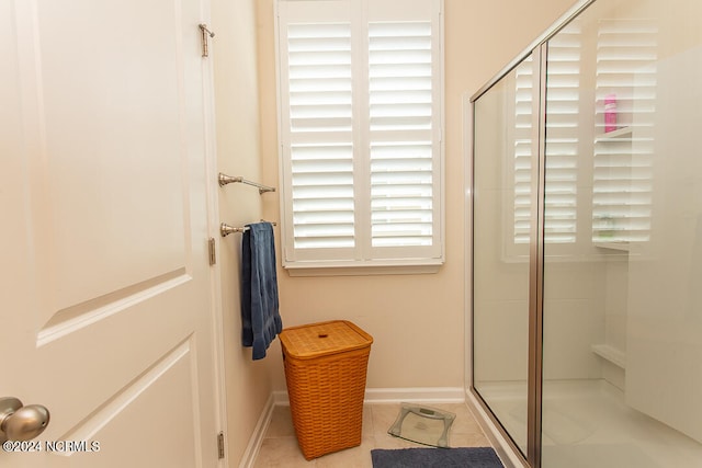 bathroom with tile patterned flooring and walk in shower