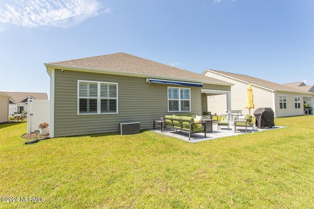 back of house featuring a patio area, outdoor lounge area, and a yard