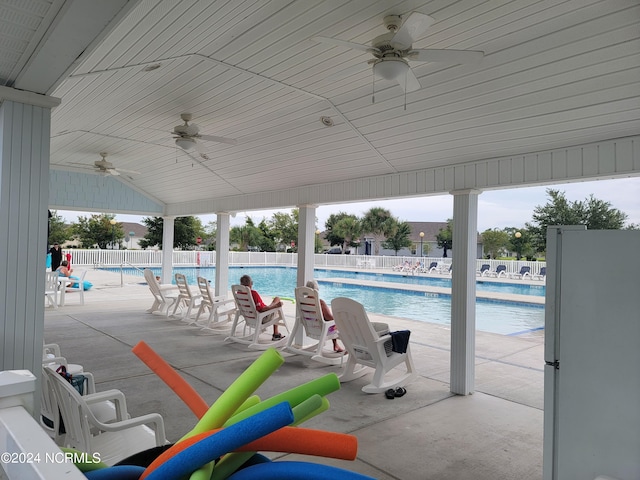 view of swimming pool with ceiling fan and a patio