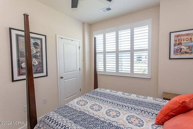 bedroom featuring multiple windows and ceiling fan