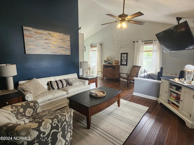 living area with vaulted ceiling, ceiling fan, baseboards, and dark wood-style flooring
