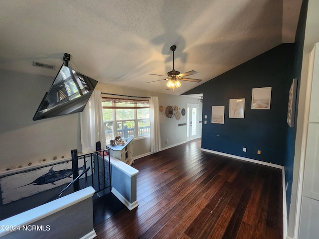 foyer featuring a textured ceiling, vaulted ceiling, dark hardwood / wood-style floors, and ceiling fan