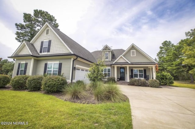 view of front of home featuring a front yard and a garage