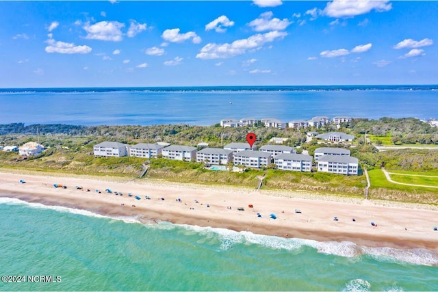 bird's eye view with a water view and a beach view