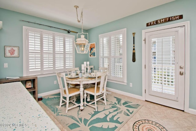 dining area with tile patterned flooring and baseboards