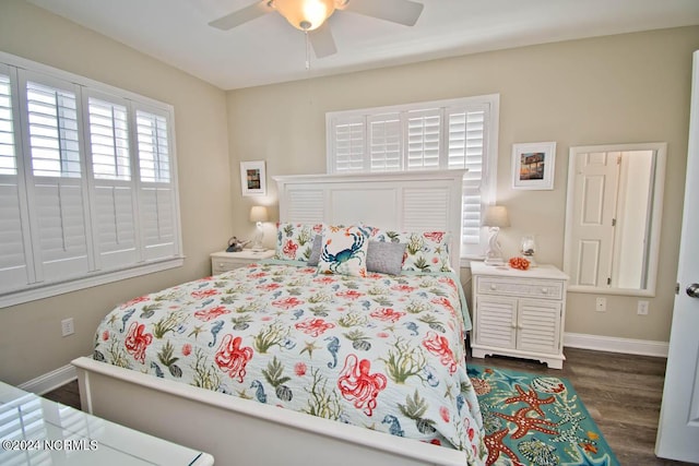 bedroom featuring a ceiling fan, baseboards, and dark wood-type flooring