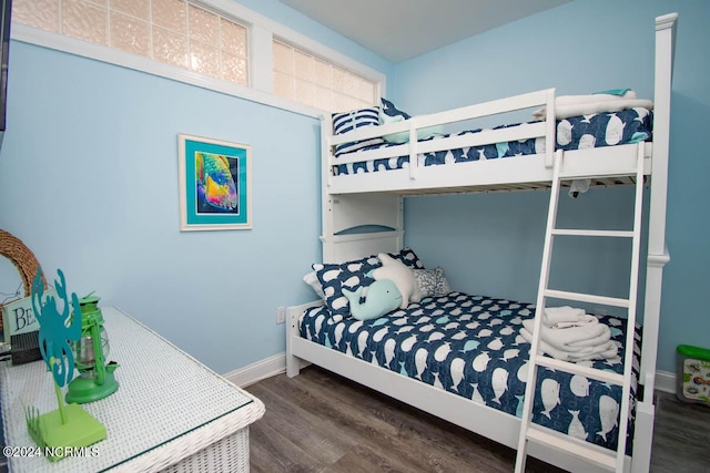 bedroom with baseboards and wood finished floors