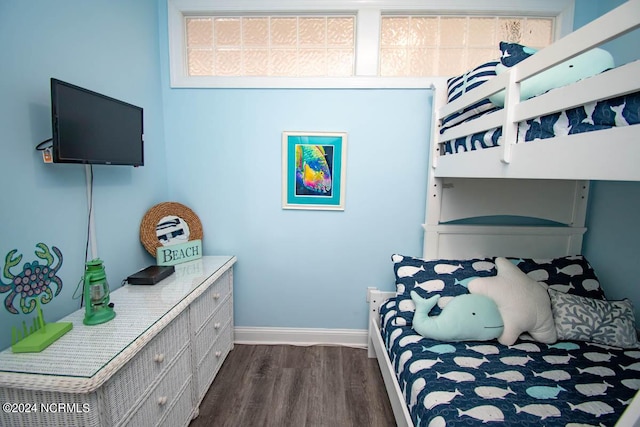 bedroom with dark wood-style floors and baseboards