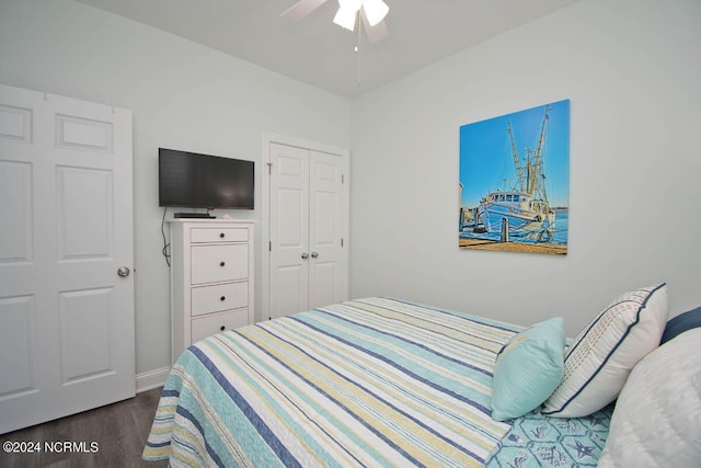 bedroom with dark hardwood / wood-style flooring, a closet, and ceiling fan