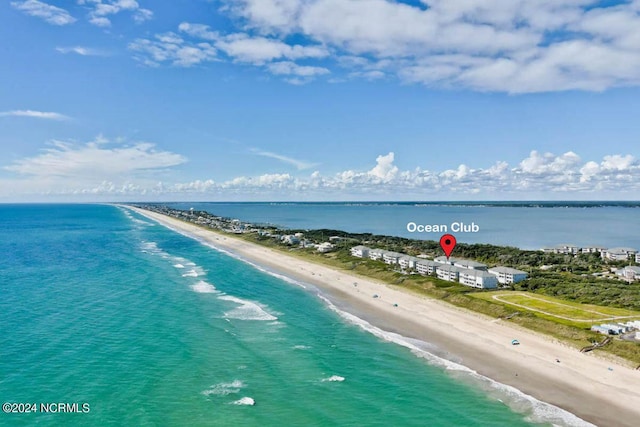 drone / aerial view featuring a water view and a beach view