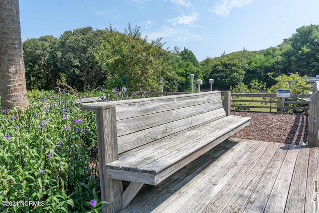 wooden terrace with a view of trees