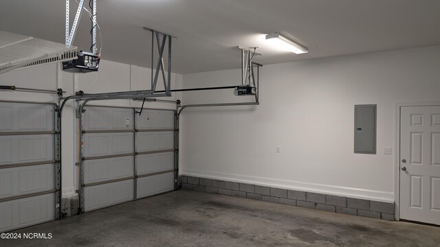 garage with electric panel and a garage door opener