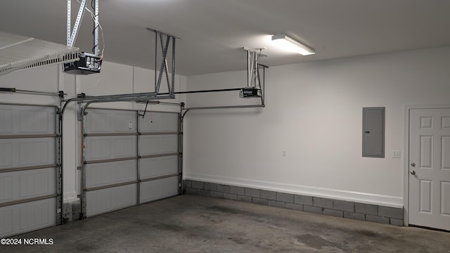 garage with a garage door opener and electric panel