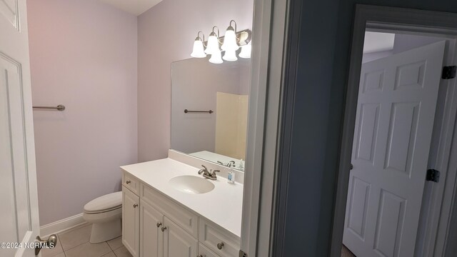 bathroom with tile patterned flooring, vanity, and toilet