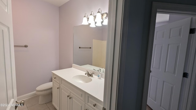 bathroom featuring baseboards, vanity, toilet, and tile patterned floors