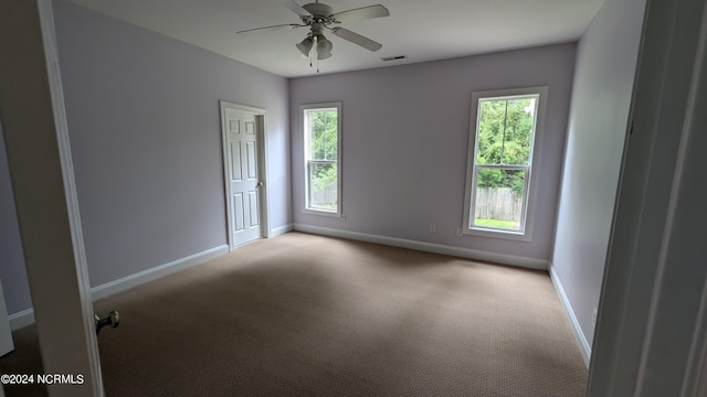 carpeted empty room featuring ceiling fan