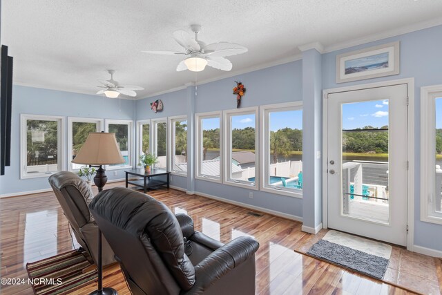 sunroom / solarium featuring ceiling fan