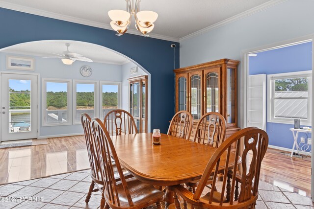 dining space featuring ornamental molding, ceiling fan with notable chandelier, and light hardwood / wood-style floors